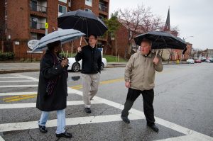 Betty Bland-Thomas, an expert in community redevelopment, leads the Rev. Steven Schave, director of LCMS Urban & Inner-City Ministry (center) and the Rev. Elliott Robertson, pastor of Martini Lutheran Church, on a walk near his church (seen in the rear) on Friday, March 28, 2014, in Baltimore, Md. LCMS Communications/Erik M. Lunsford 