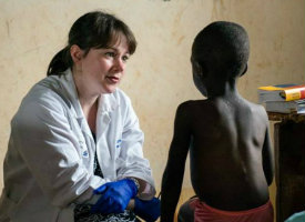 A doctor treating a young patient on a clinical trip in Kenya