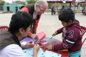 Team member in Peru teach dental health on a Community Health Education trip