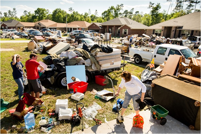 Victims sorting through their belongings after severe floods.