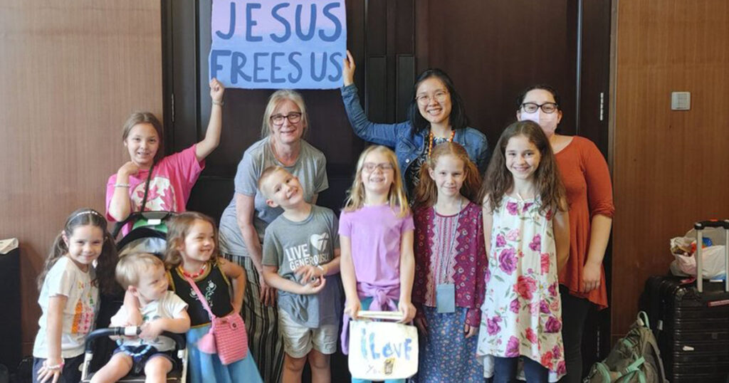 Volunteers Tracy Beasley, Caroline Blankenship, Con-Ning Yen and participant children hold a “Jesus Frees Us” sign during an LCMS Short-Term Mission trip in Asia in January 2024. The volunteers from Good Shepherd Lutheran Church in Roanoke, Va., prepared and hosted a Bible camp for children of the Asian international workers. (Caleb Ching)