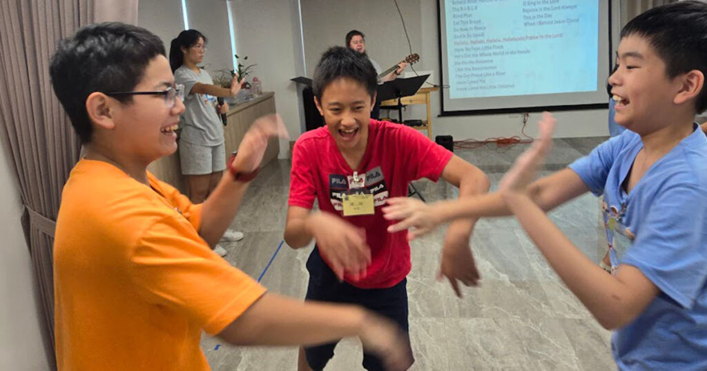 Some of the older male participants in the English Bible Camp enjoy music time at Holy Word Church in Hsinchu City, Taiwan, in July 2024. (Myles Williams)